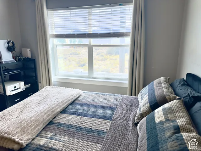 Neutral wall tones featuring a large dual-pane window with integrated horizontal blinds