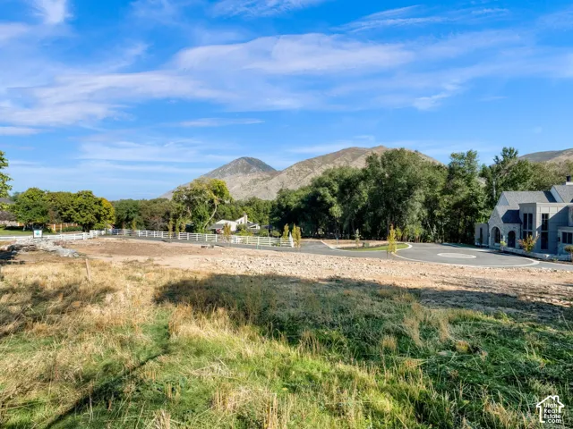 Expansive land parcel featuring a developing cul-de-sac and mountain scenery