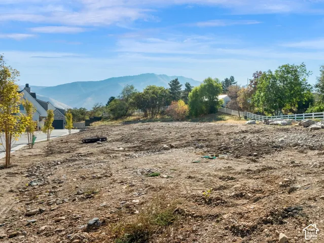Graded lot with a paved street and mountain backdrop