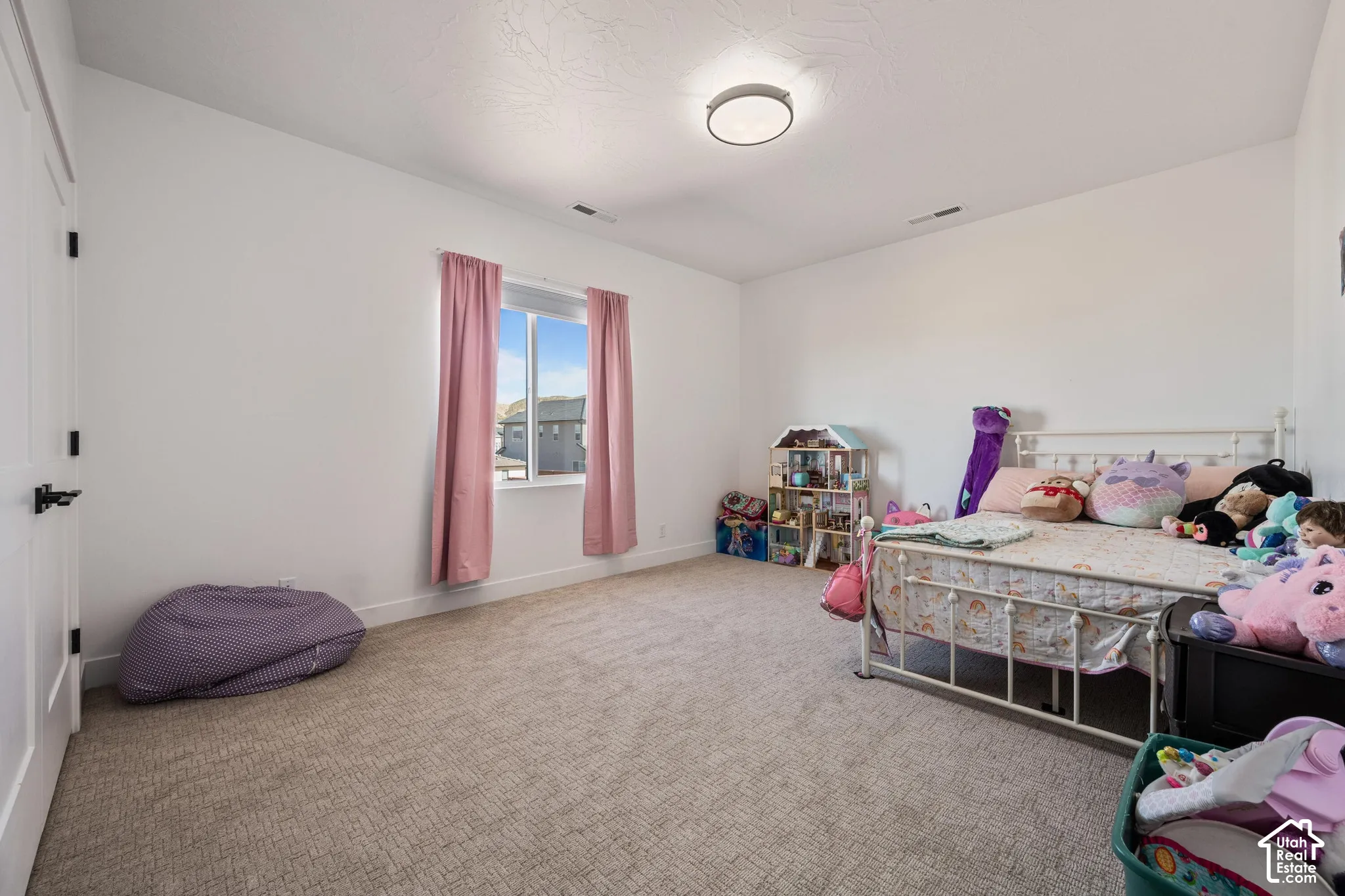 Neutral interior featuring high ceilings, wall-to-wall carpeting, and a flush-mount circular lighting fixture