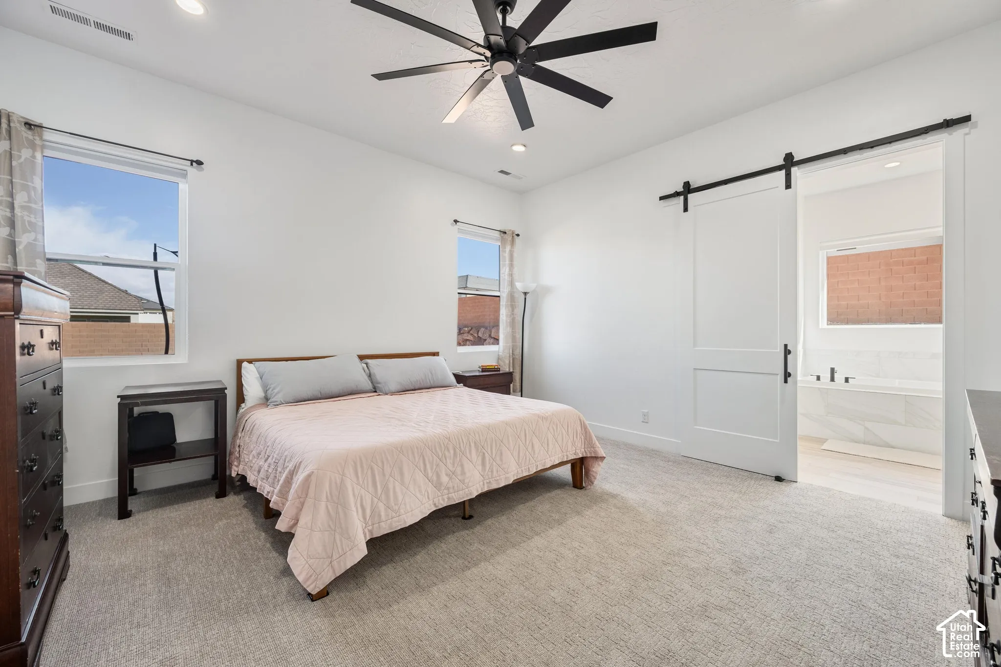Primary Bedroom featuring carpeted flooring, a multi-blade ceiling fan, recessed lighting, and a white interior sliding barn door
