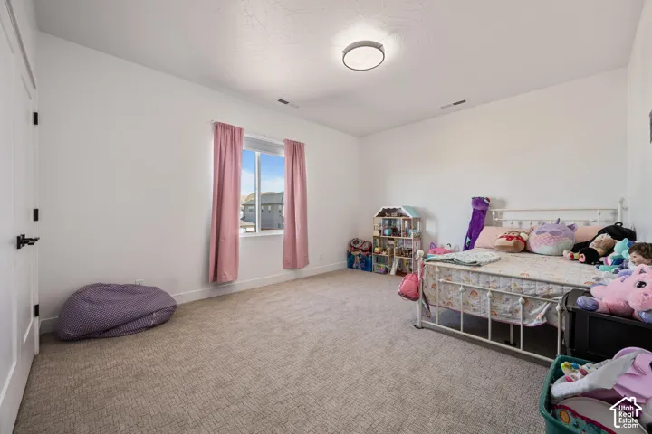 Neutral interior featuring high ceilings, wall-to-wall carpeting, and a flush-mount circular lighting fixture