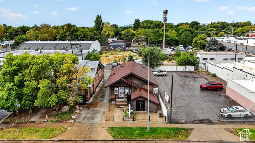 Aerial perspective of a detached property featuring a gable roofline, exterior siding, and a dedicated paved lot