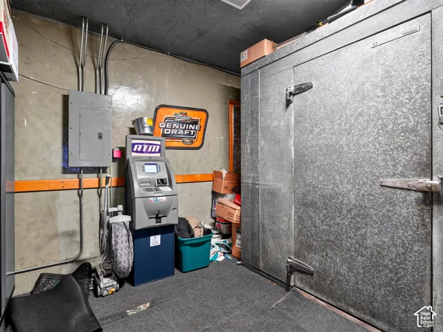 Large-scale commercial-grade walk-in cooler with a galvanized metal finish and industrial locking hardware