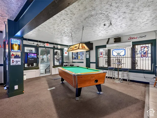 Multi-purpose area featuring a structural steel support column, recessed lighting, and wall-mounted climate control unit