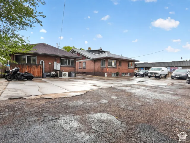 Brick exterior construction with multiple roof lines and dedicated off-street concrete parking area