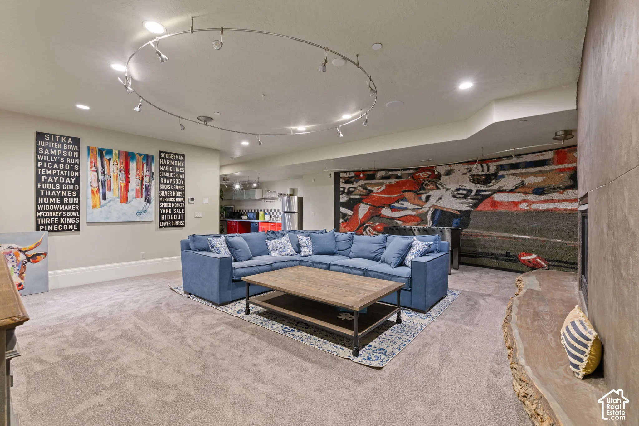Circular track lighting, stone-finish fireplace surround, and custom live-edge wood hearth