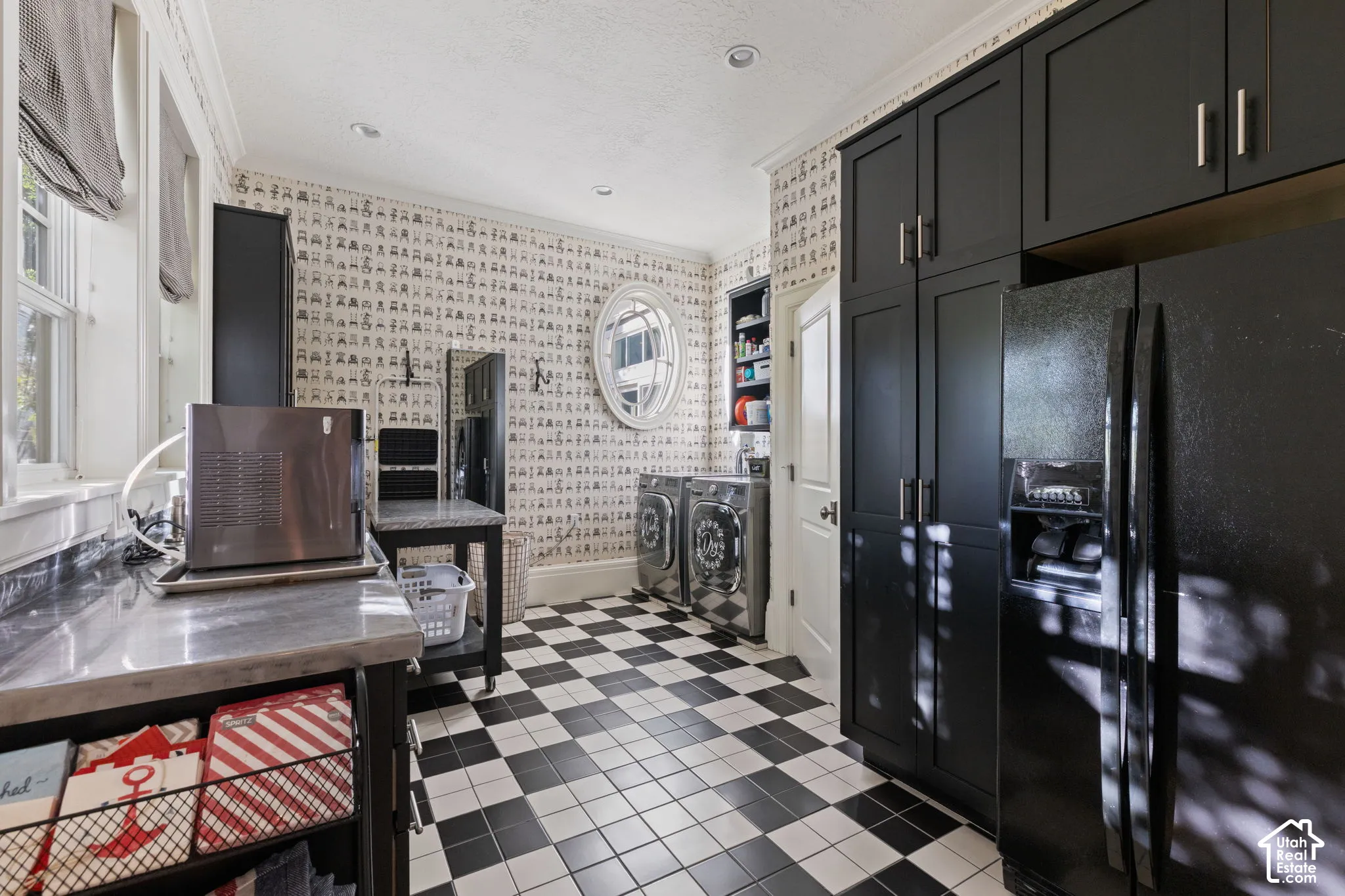 Utility space featuring full-height matte black cabinetry, checkerboard tile flooring, a built-in oval window, and recessed ceiling lighting
