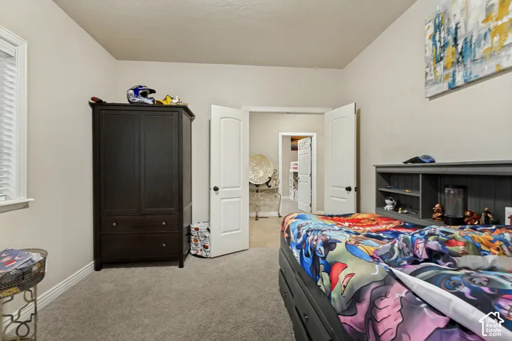 Interior room featuring neutral wall paint, carpeted flooring, and double-panel doors