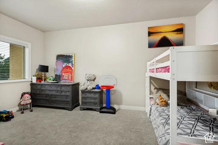 Neutral interior room featuring neutral wall paint, wall-to-wall carpeting, and a window with horizontal blinds