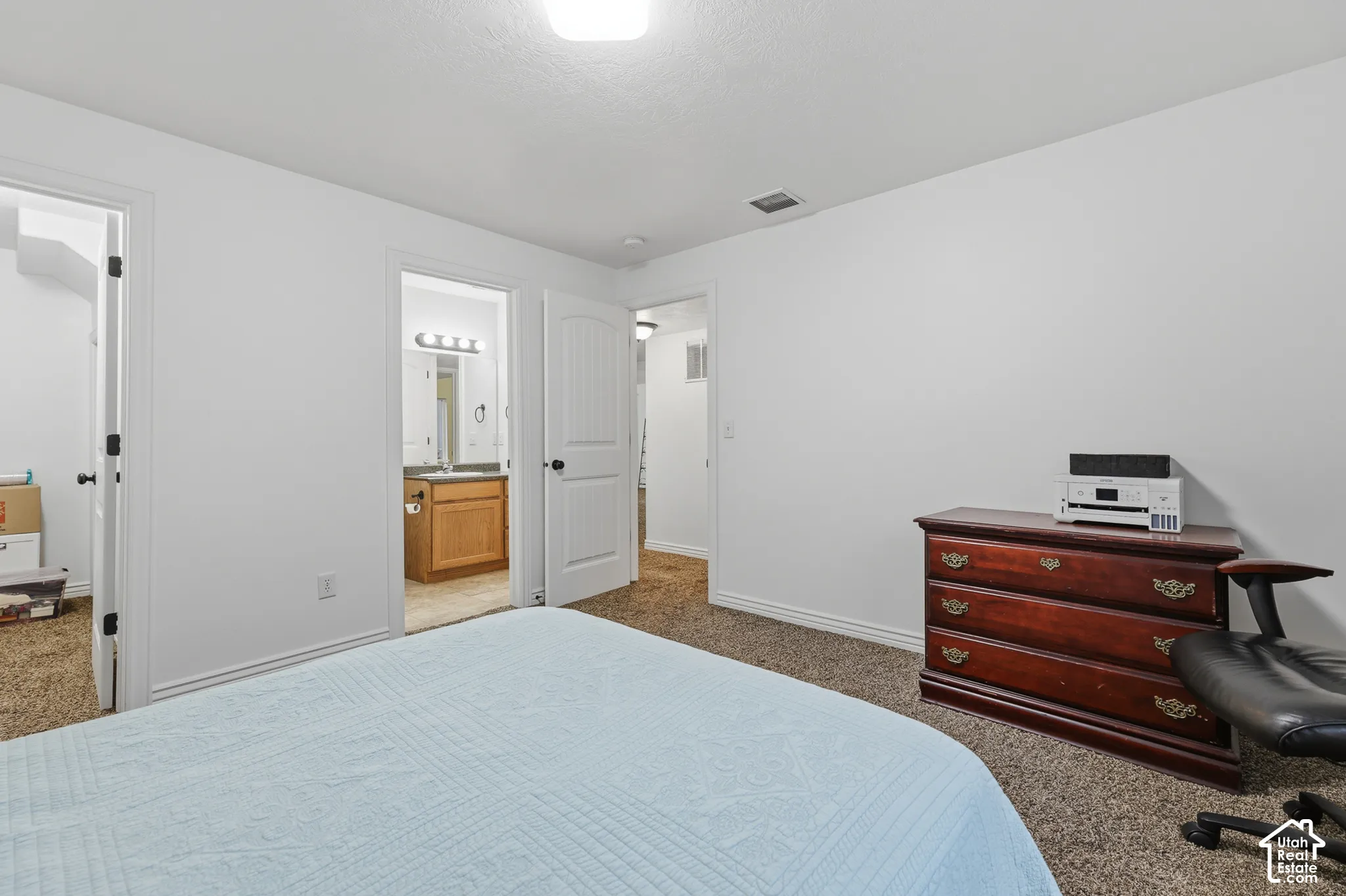 Neutral wall finishes, textured carpeting, and solid-core interior doors with arched-top detailing