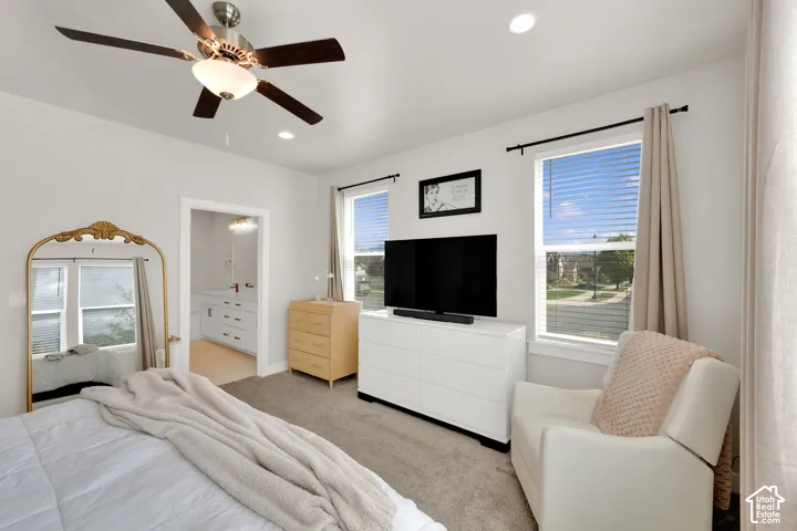 Neutral-toned bedroom featuring carpeting, recessed lighting, and a multi-blade ceiling fan with an integrated light fixture