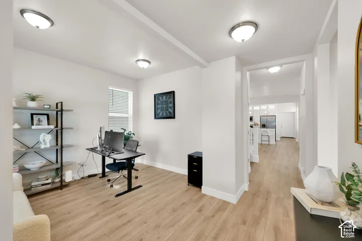 Wood-finish flooring, recessed ceiling lighting, and a neutral color palette