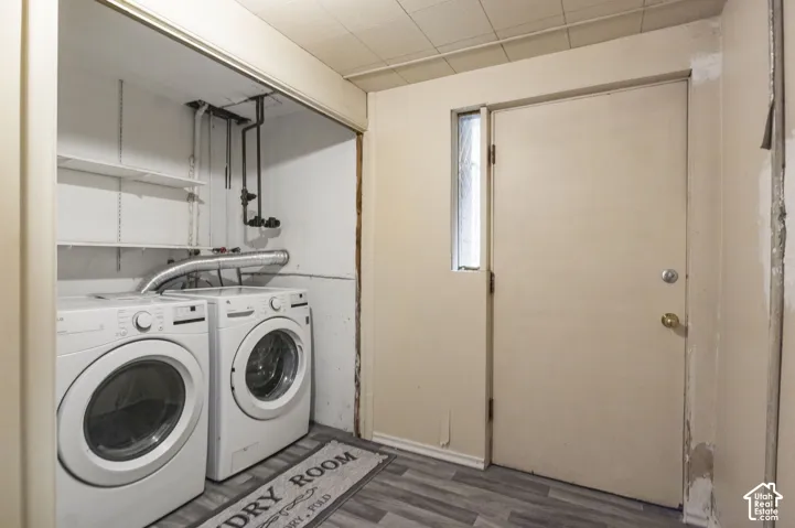 Dedicated utility area featuring wood-finish flooring, built-in shelving, and exterior access door with a sidelight window