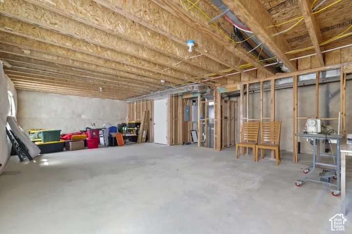 Unfinished lower level featuring exposed wood-joist ceilings, concrete flooring, and insulated foundation walls
