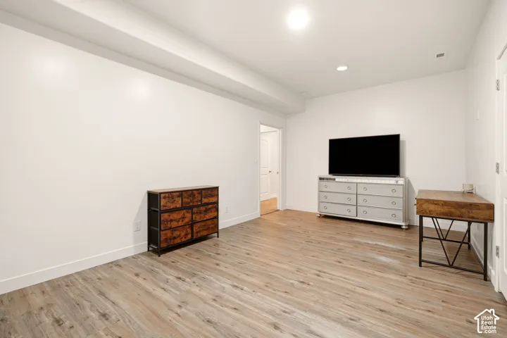 Interior room featuring wood-finish flooring, recessed lighting, and neutral wall paint