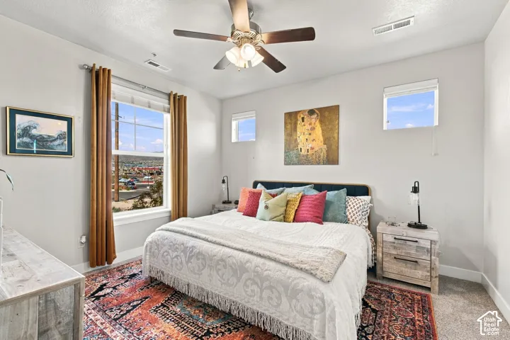 Recessed lighting, ceiling fan with integrated lighting, multiple windows, and light gray wall paint