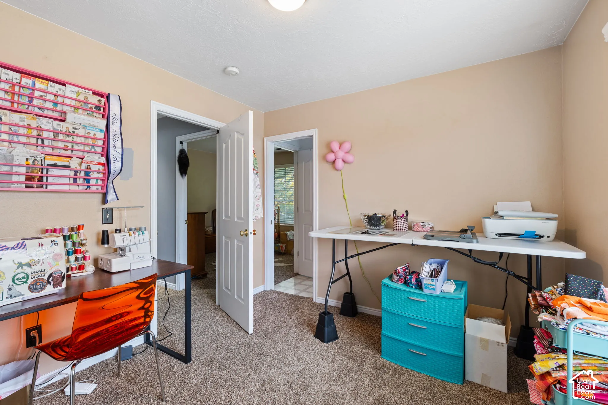 Interior space featuring wall-to-wall carpeting and two paneled interior doors with brass hardware