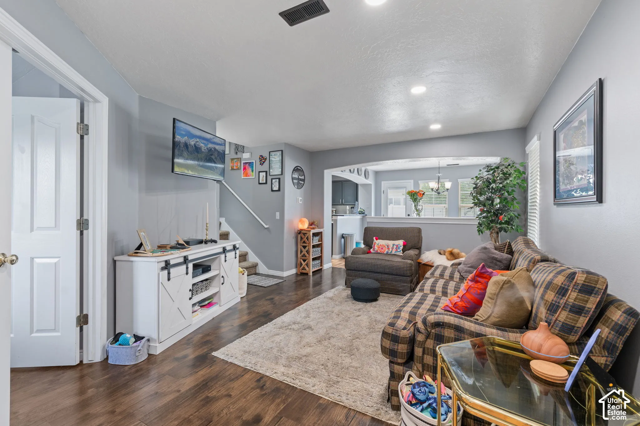 Living area featuring wood-finish flooring, recessed lighting, and a neutral color palette