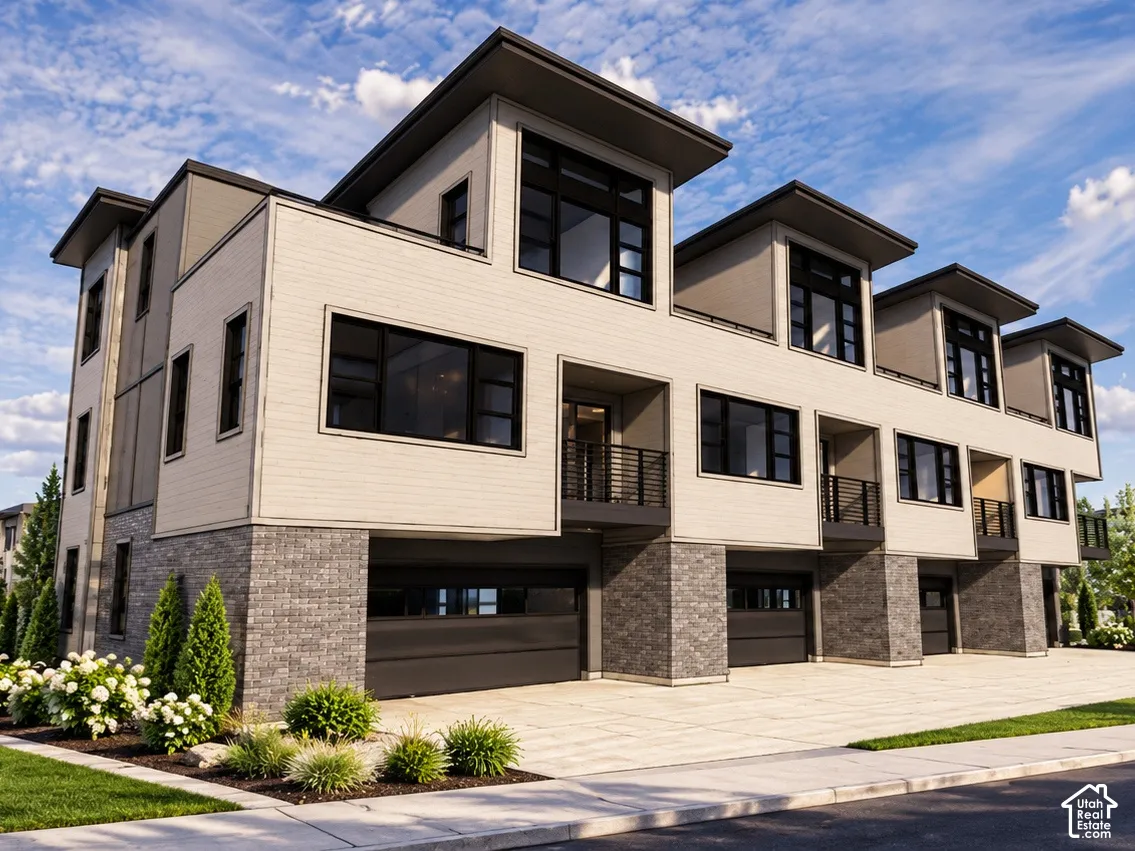 Contemporary multi-story exterior featuring a brick and horizontal siding facade, metal-framed windows, integrated garage doors, and private recessed balconies