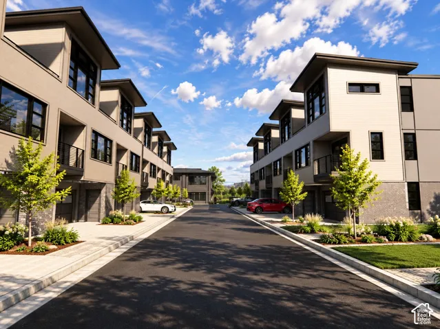 Multi-level modern residences featuring light-toned smooth siding, charcoal masonry accents, tiered architectural rooflines, and black-frame multi-pane windows