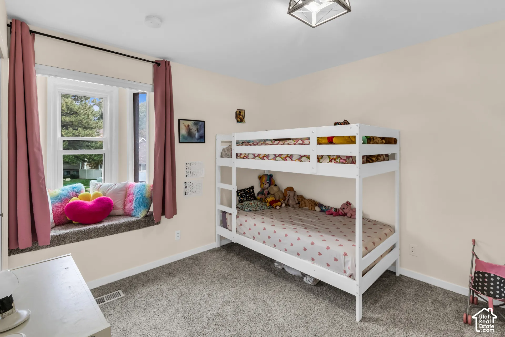 Built-in window seat, neutral wall palette, carpeting, and multi-paned window