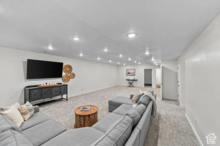 Expansive room featuring wall-to-wall carpeting, recessed ceiling lighting, and neutral-tone walls