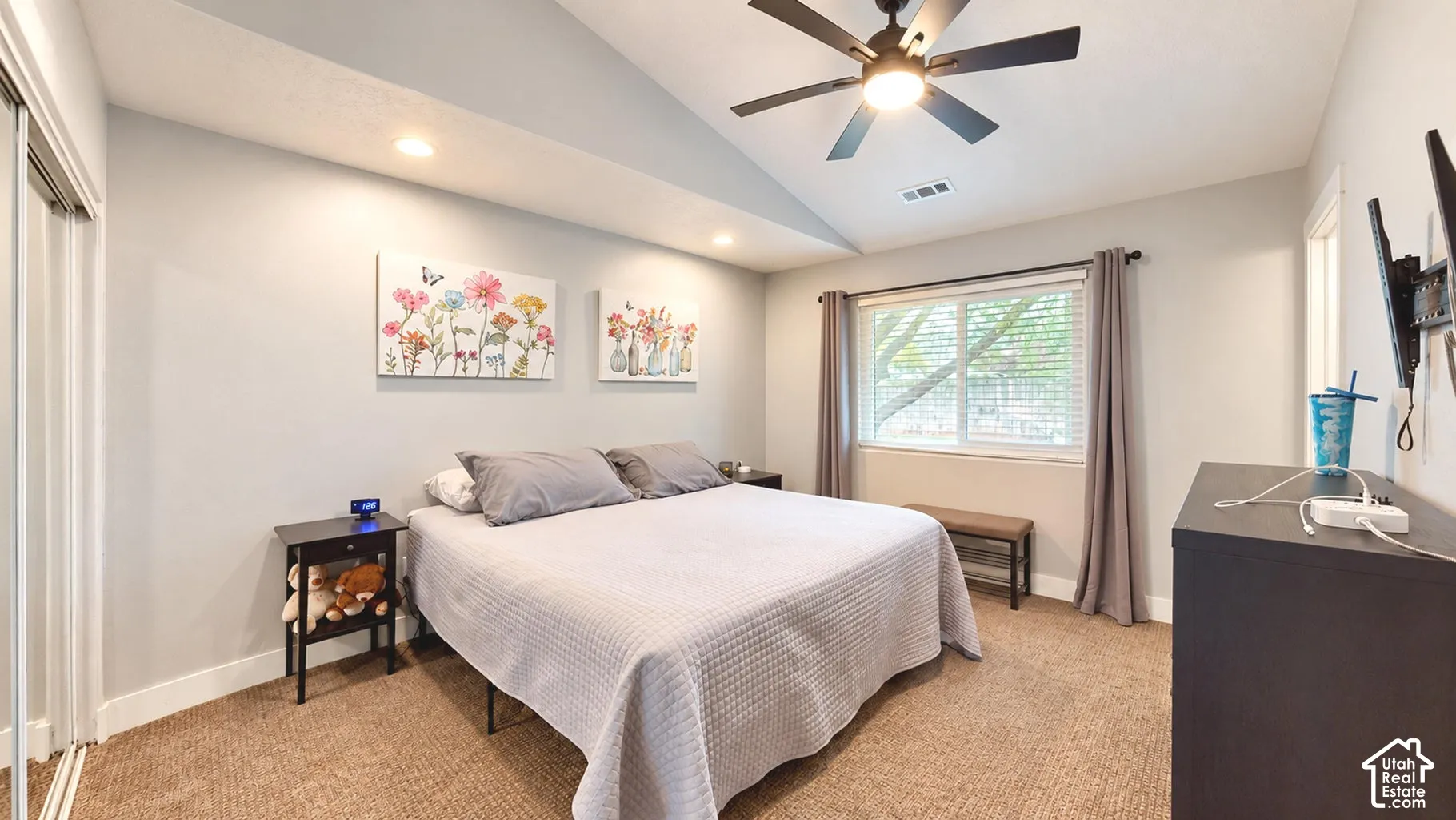 Vaulted ceilings, neutral wall tones, recessed lighting, and a dark-finish ceiling fan with integrated lighting