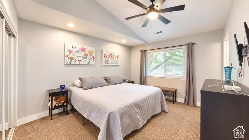 Vaulted ceilings, neutral wall tones, recessed lighting, and a dark-finish ceiling fan with integrated lighting