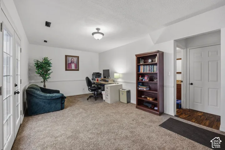 French doors with glass panes, wall-to-wall carpeting, chair rail molding, ceiling-mounted light fixture, and six-panel interior door