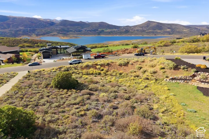 Expansive landscape featuring distant mountains and a large body of water