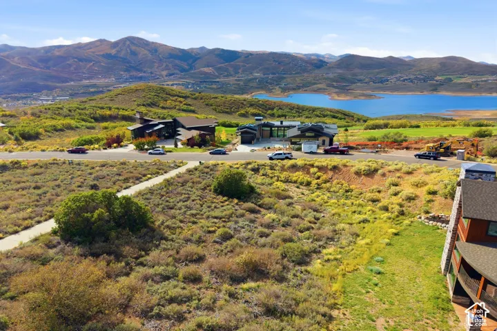 Expansive hillside setting with a distant lake, mountain backdrop, and contemporary-style residences