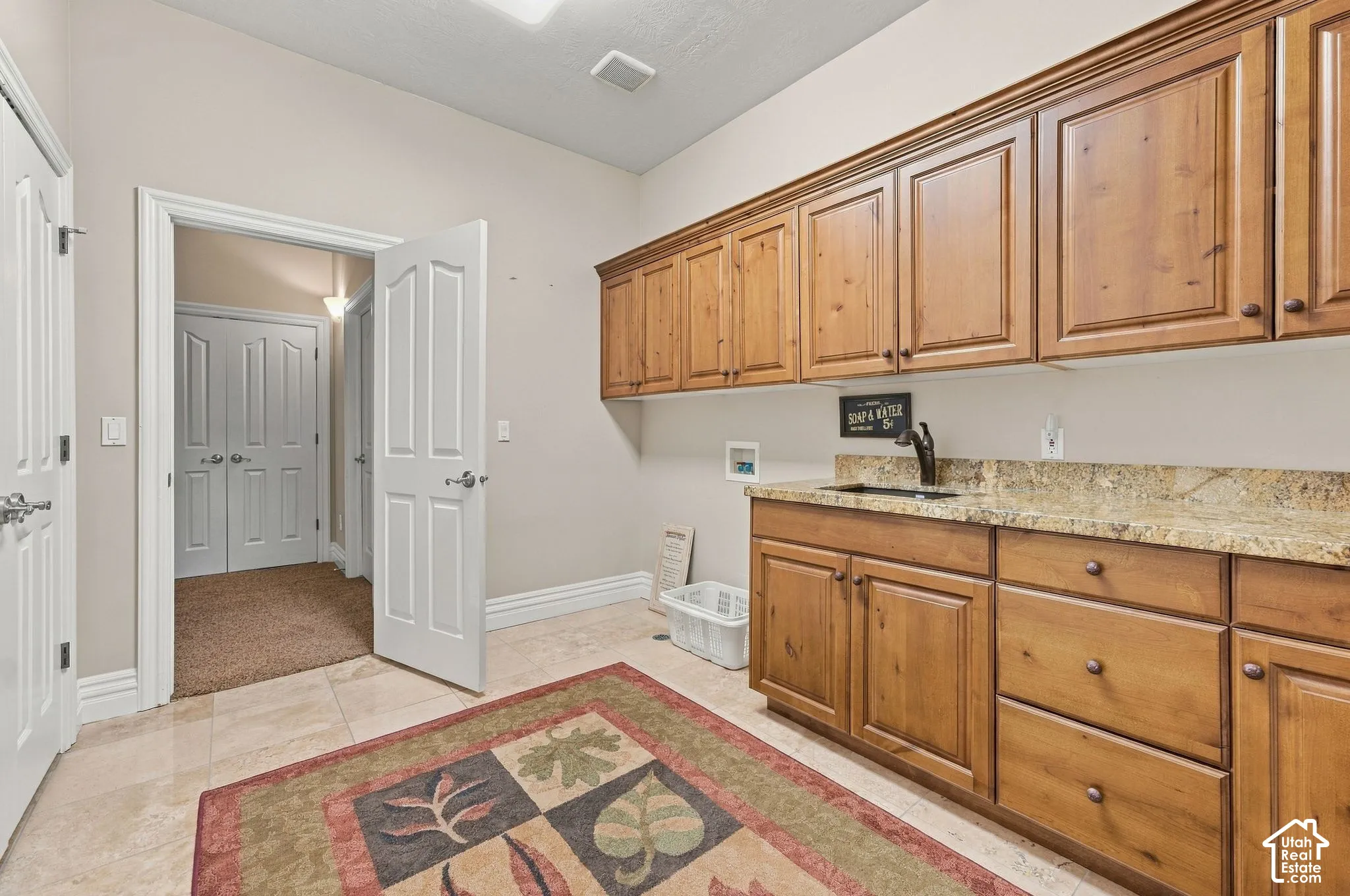 Very Large Downstairs Laundry Room with Scrub Sink, Granite, Tile and Tons of Cabinetry with Full Wall of Storage Closets