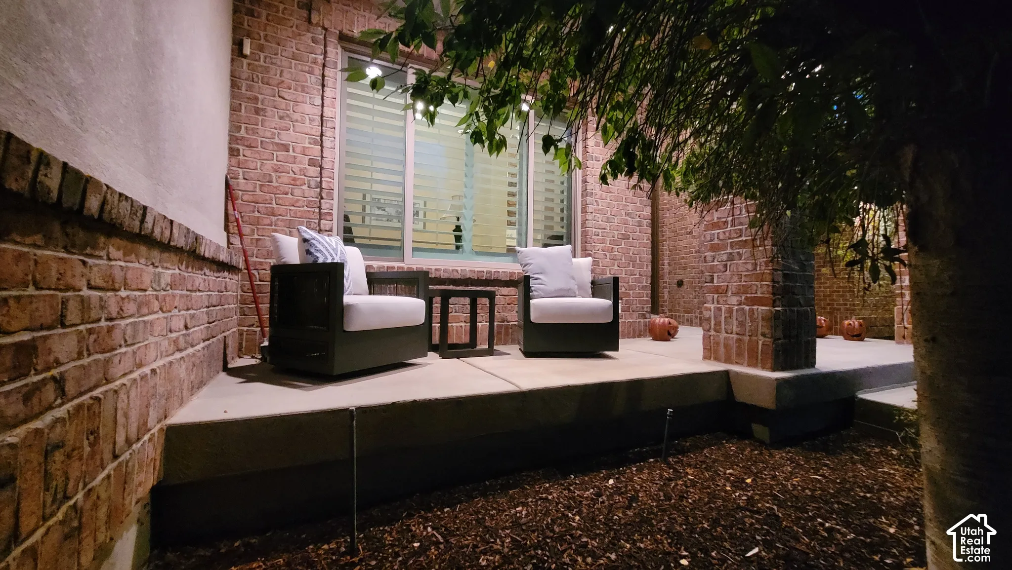 Covered porch featuring brick masonry exterior walls, a concrete patio foundation, and a multi-pane window