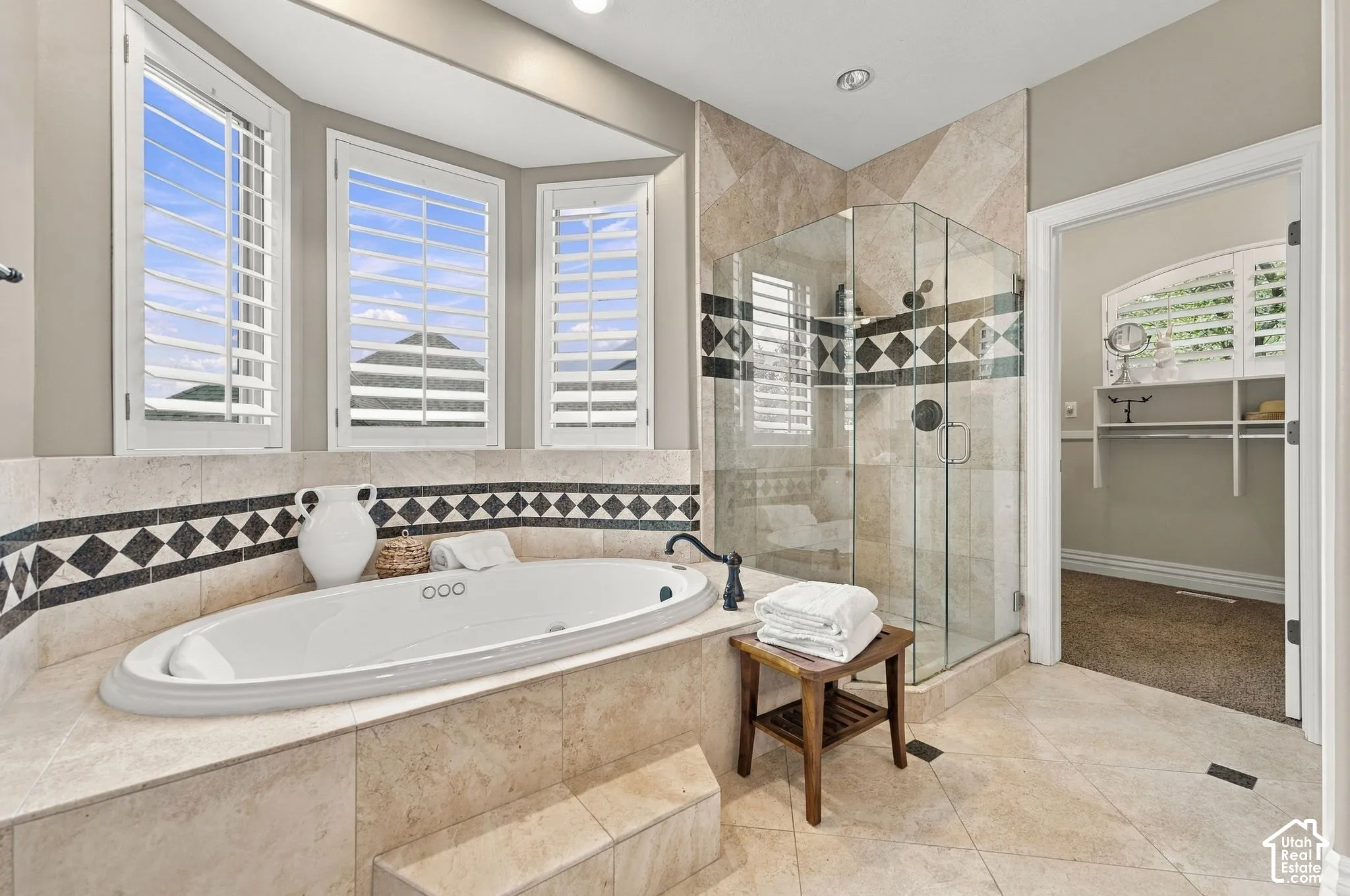Primary Bathroom features Luxurious Jetted Tub to Soak in and Tile Shower with Euro Glass Doors
