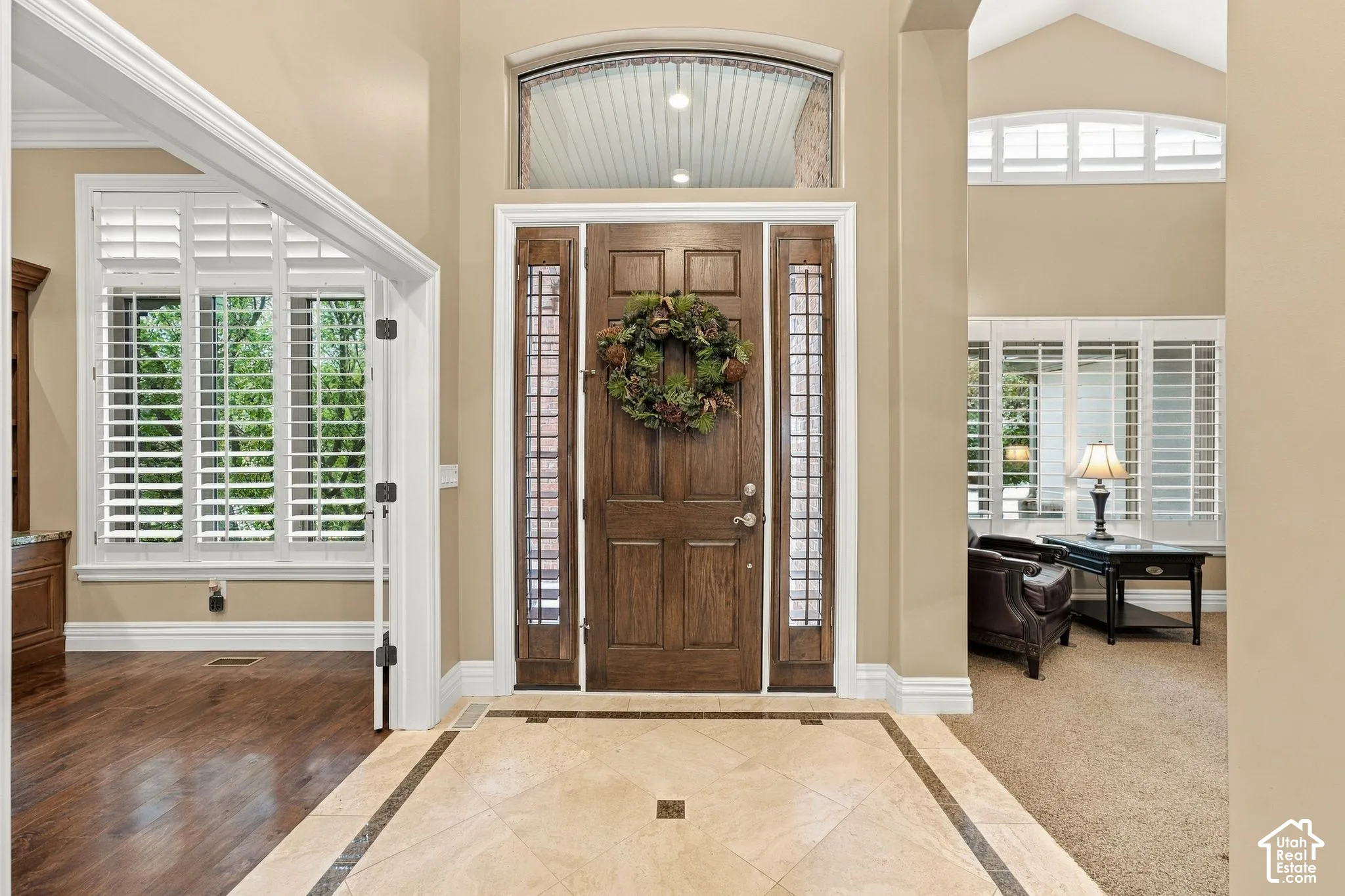 Beautiful Entry with Custom Tile Floors, Transom and Decorative Windows