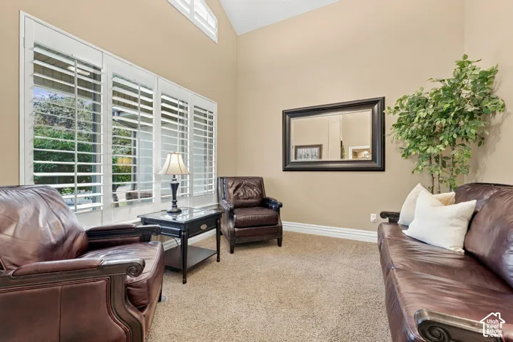 Generous Vaulted Living Room with Large Window and Plantation Shutters
