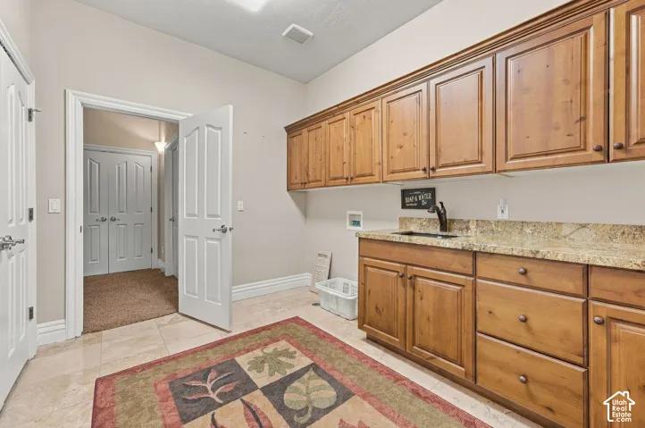 Very Large Downstairs Laundry Room with Scrub Sink, Granite, Tile and Tons of Cabinetry with Full Wall of Storage Closets