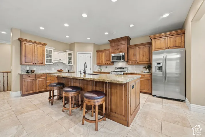 Large Gourmet Kitchen with Custom Cabinetry and Gleaming Stainless Steel Appliances, Double Gas Ovens