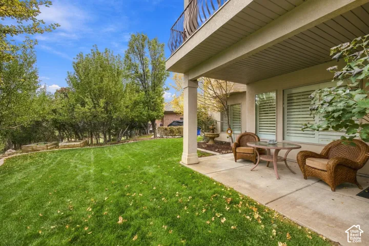 Basement Walkout to Covered Patio with Lovely Fountain, Vegetable Planter Boxes, and Mature Trees