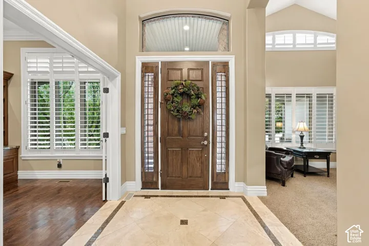 Beautiful Entry with Custom Tile Floors, Transom and Decorative Windows