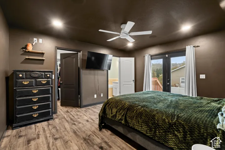 Wood-finish flooring, recessed lighting, ceiling fan, and double-door access to an exterior deck