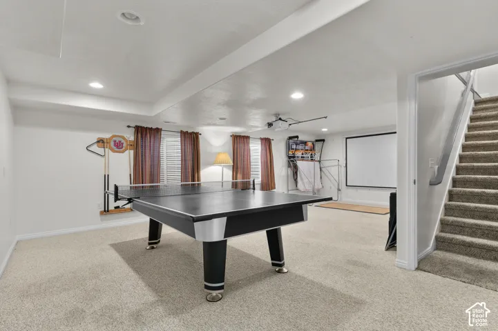 Finished lower level featuring recessed lighting, carpeted flooring, and a projection screen