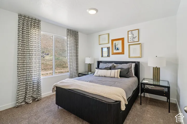 Neutral-toned carpeted flooring, white walls, and a recessed ceiling light fixture