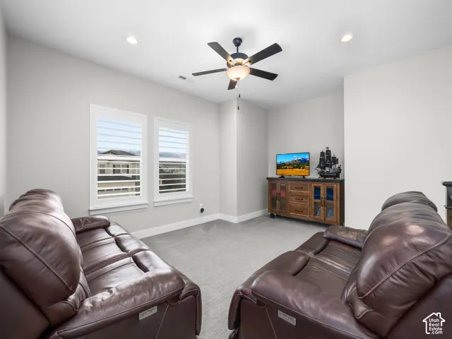 Room featuring neutral wall paint, carpeted flooring, recessed lighting, a ceiling fan with integrated lighting, and dual windows outfitted with shutters