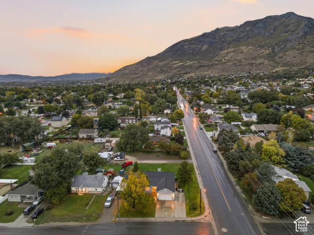 Aerial perspective featuring proximity to mountain topography and established tree canopy