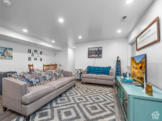 Neutral-toned interior featuring recessed lighting and wood-finish flooring