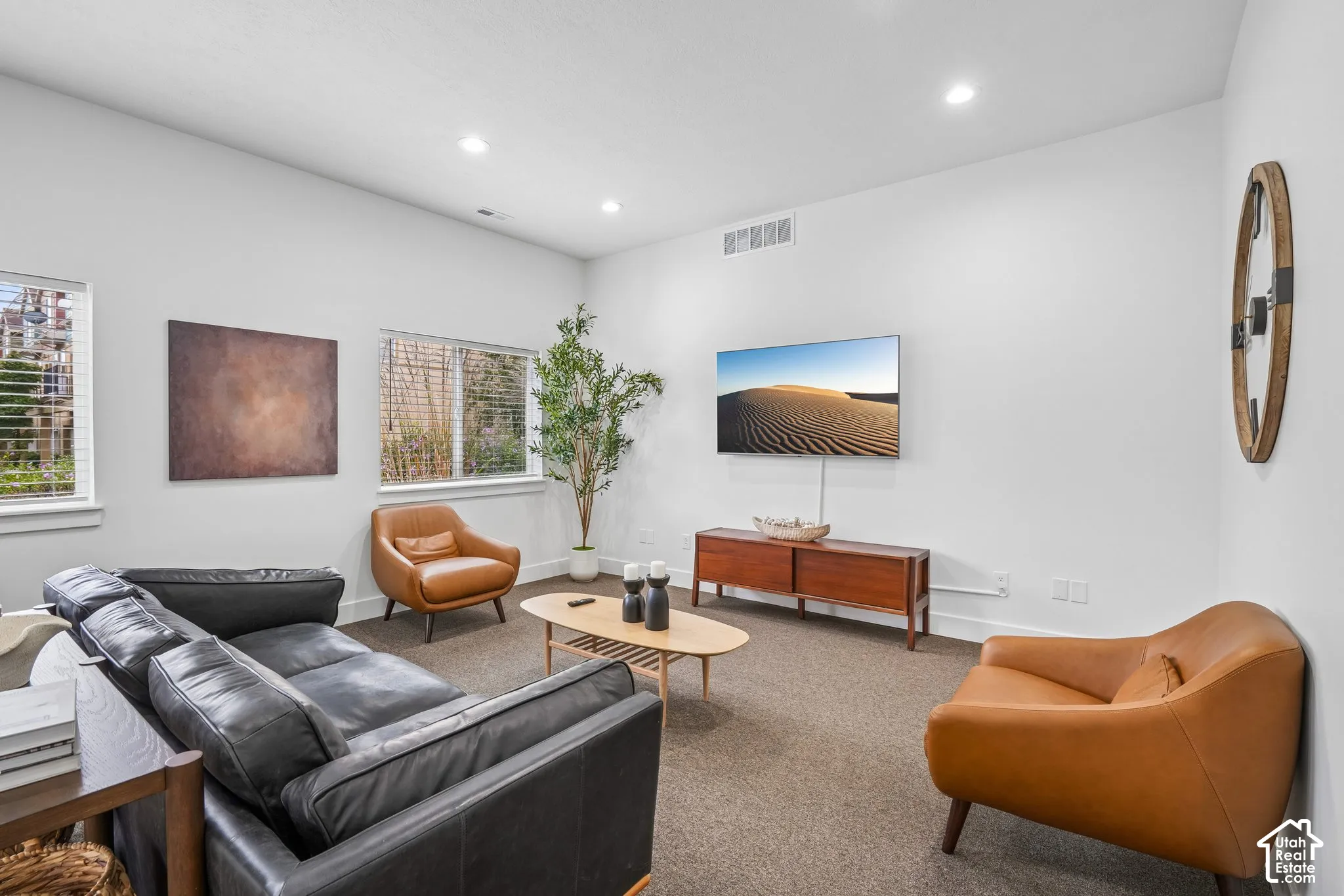 Living area featuring recessed lighting, carpeting, and multiple windows