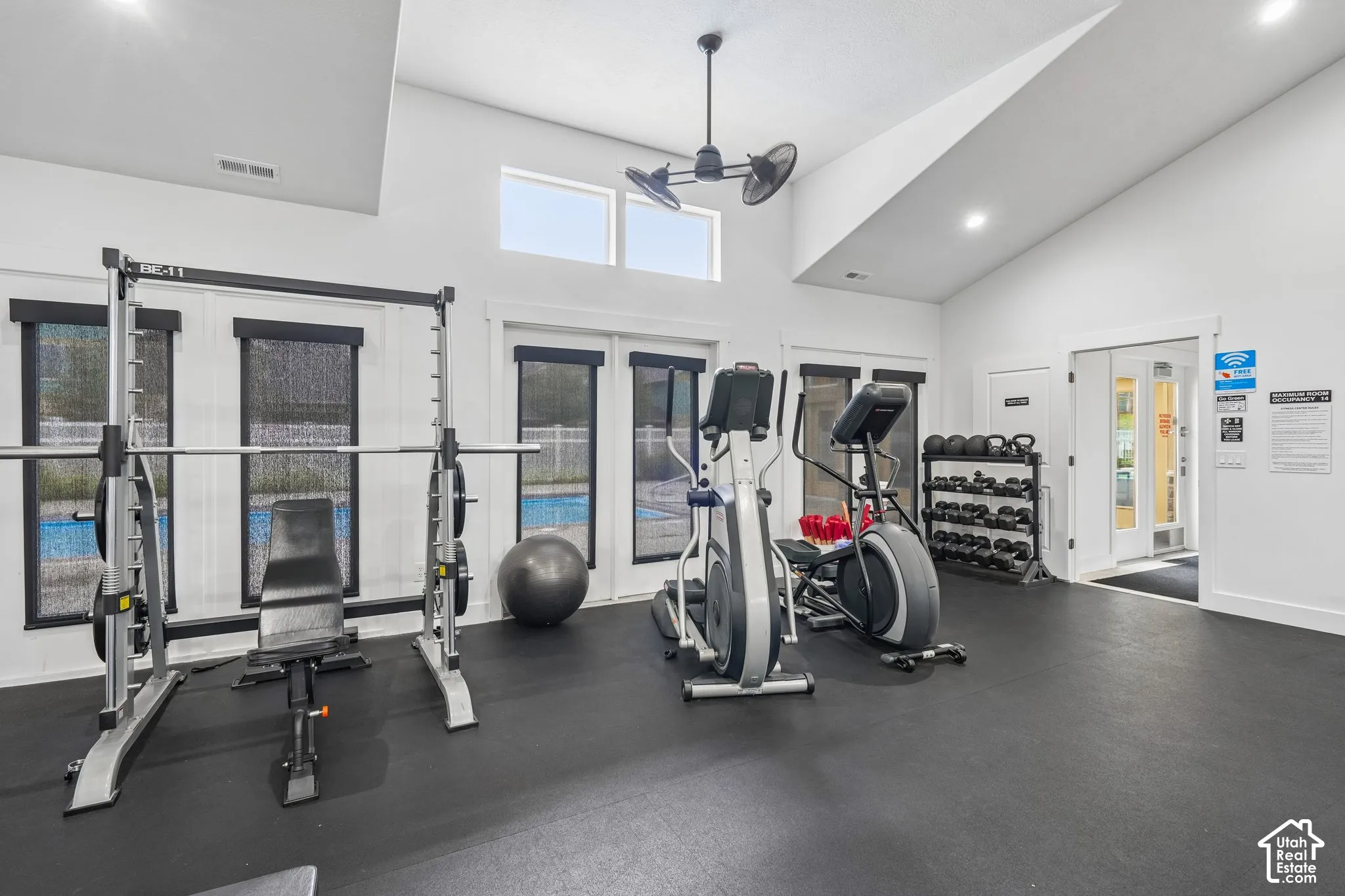 Vaulted ceilings, high-contrast black and white interior finish, expansive glass panels, and rubberized flooring