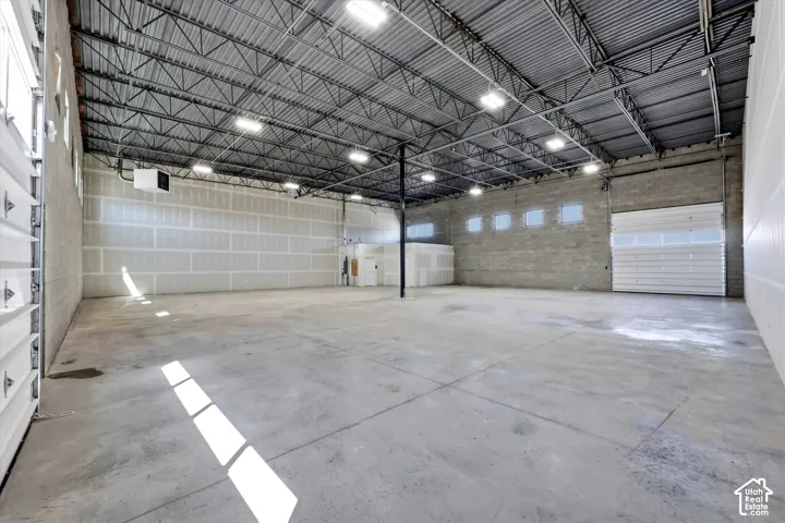 Expansive concrete flooring and exposed metal truss ceiling